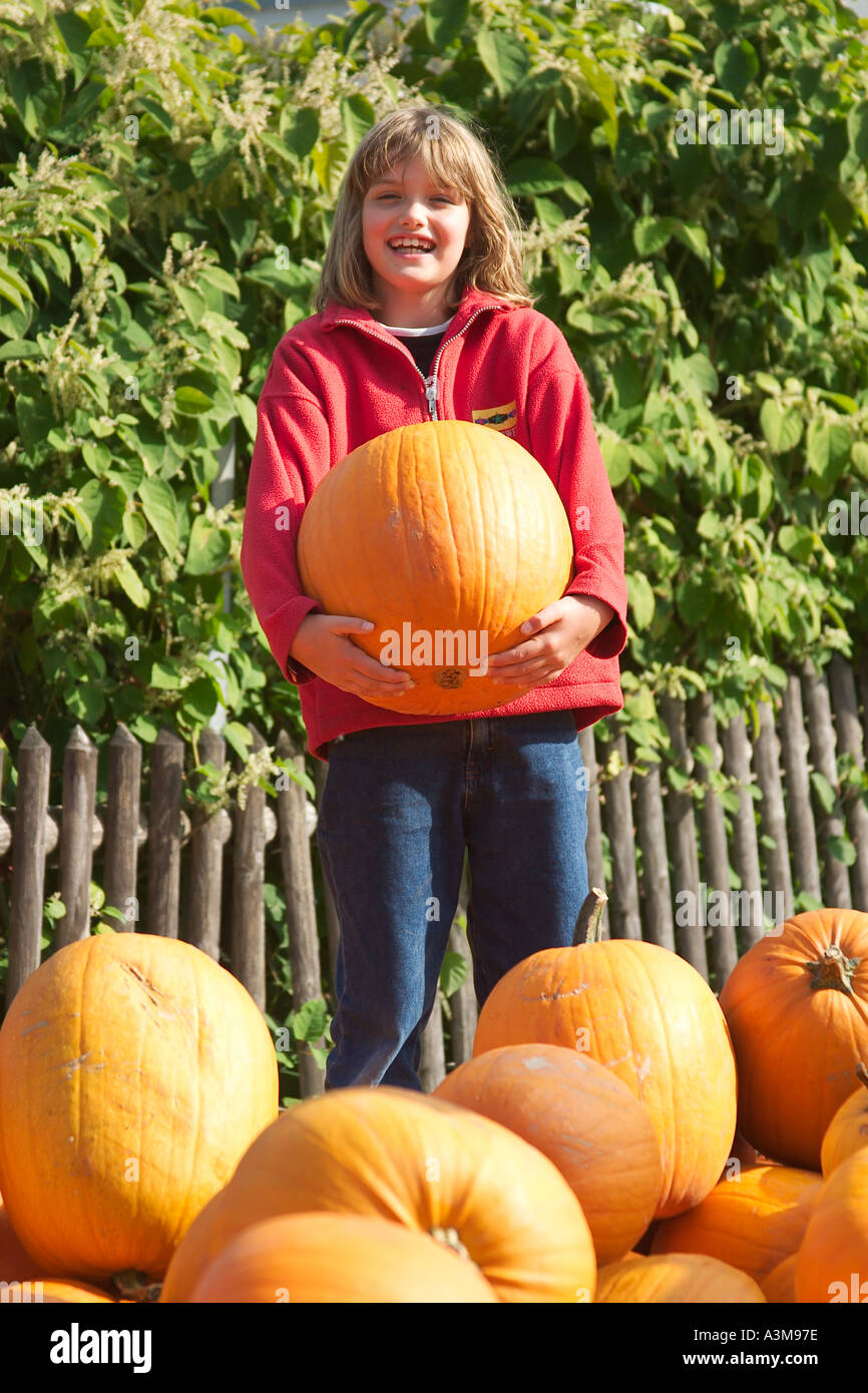 MR Little girl holding a big pumpkin Stock Photo - Alamy