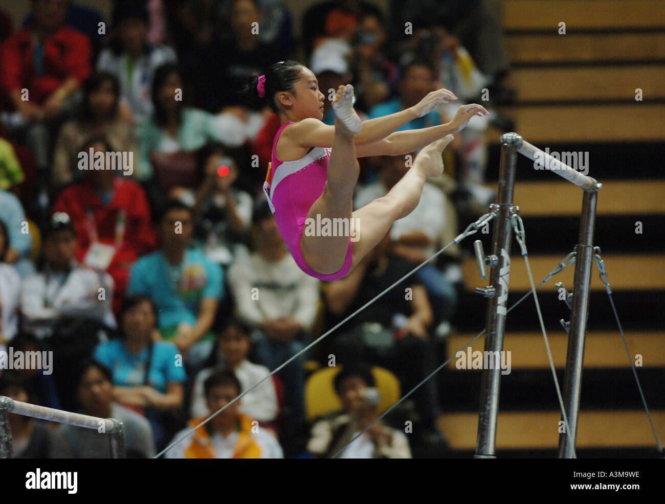 gymnastic athlete on uneven bars Stock Photo Alamy
