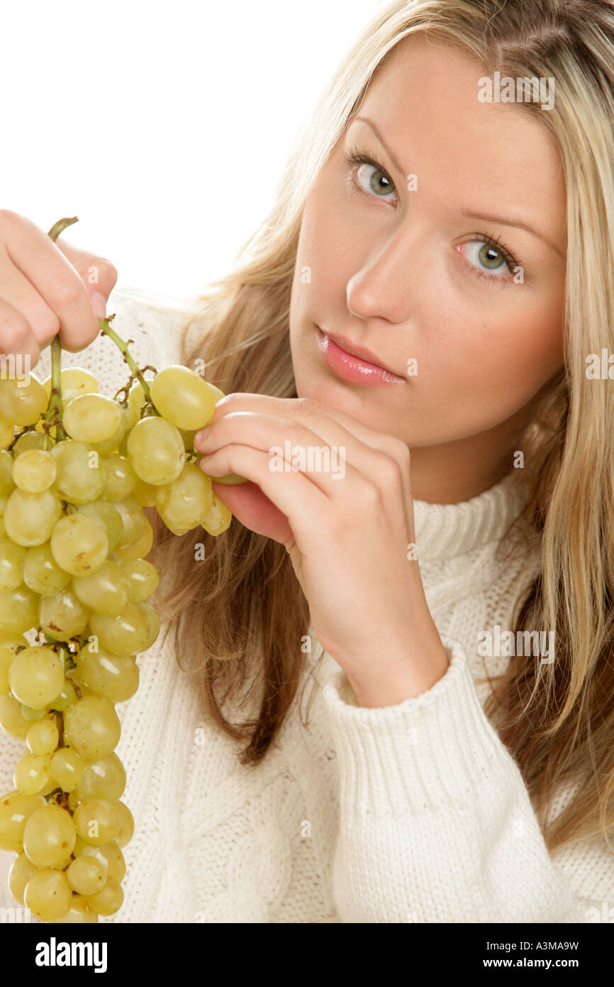 Young woman eating grapes Stock Photo