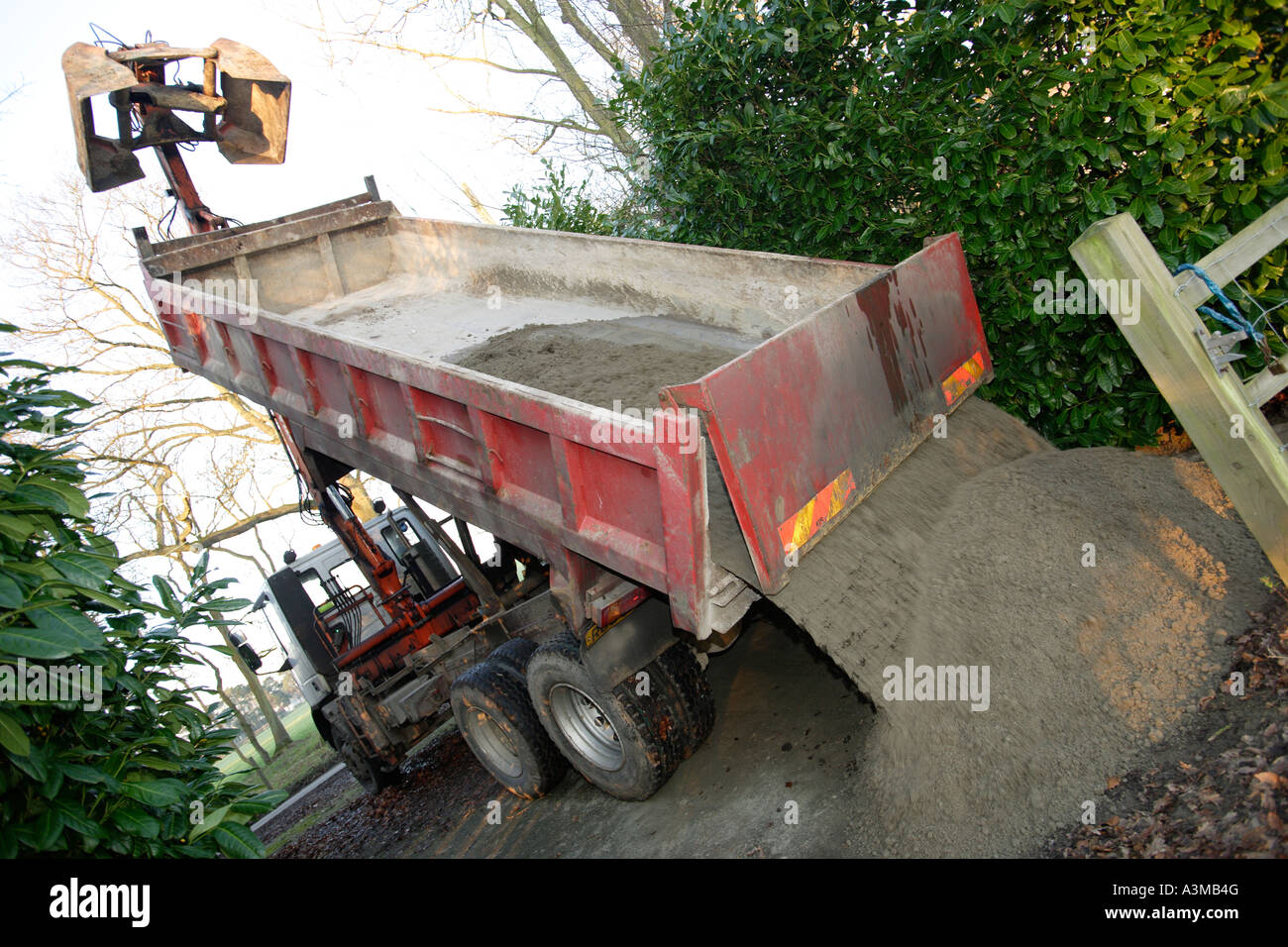 Dumper truck emptying load of sand and cement Stock Photo