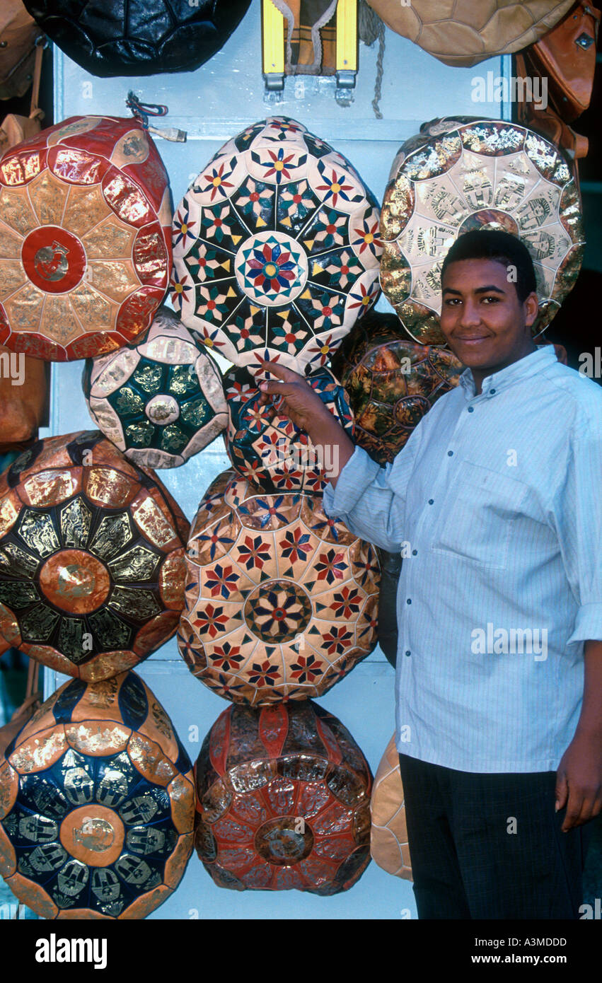 Trader with decorative display of footrests Egypt Stock Photo