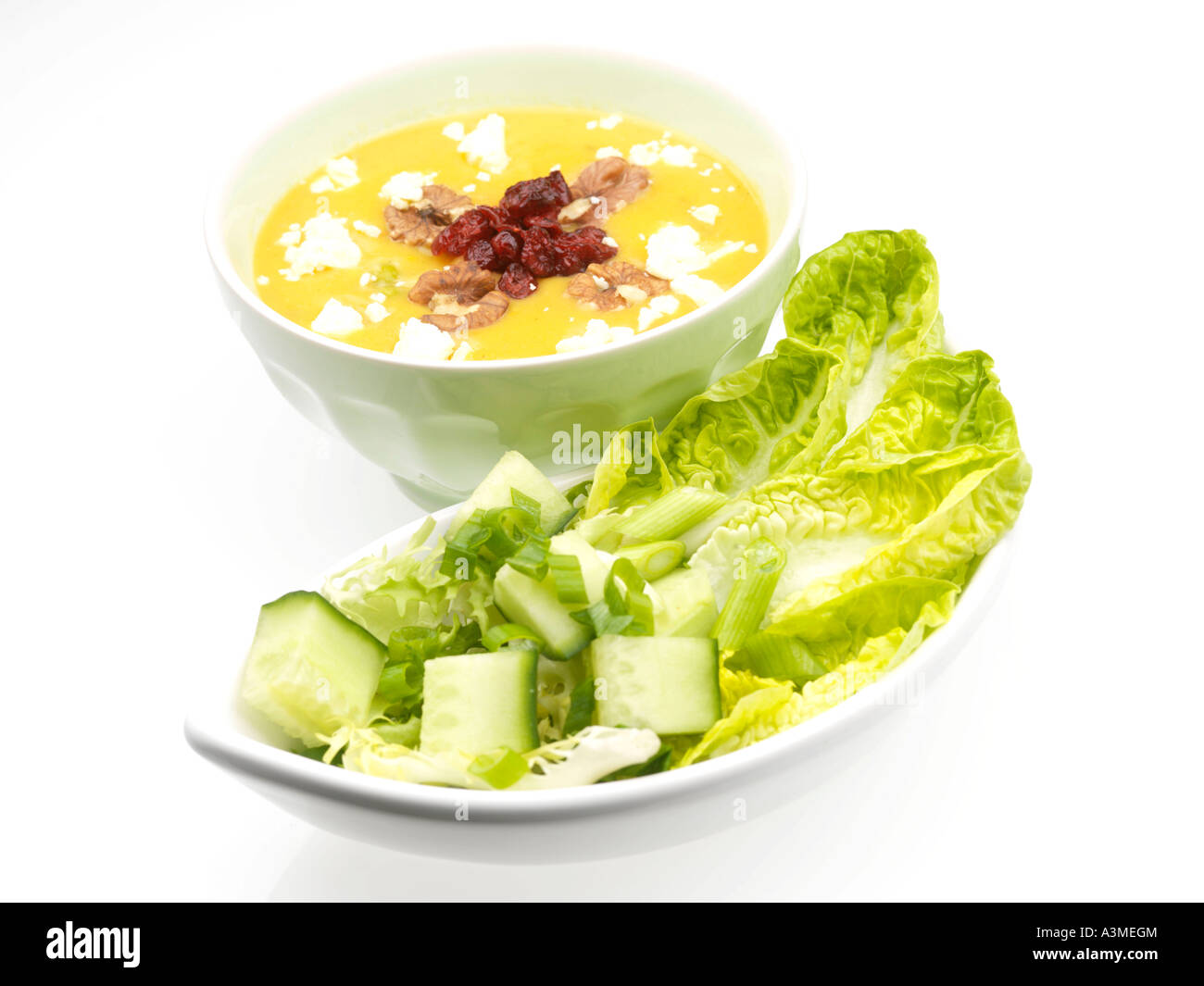 Vegetable Soup with Cranberry and Walnut Garnish Stock Photo