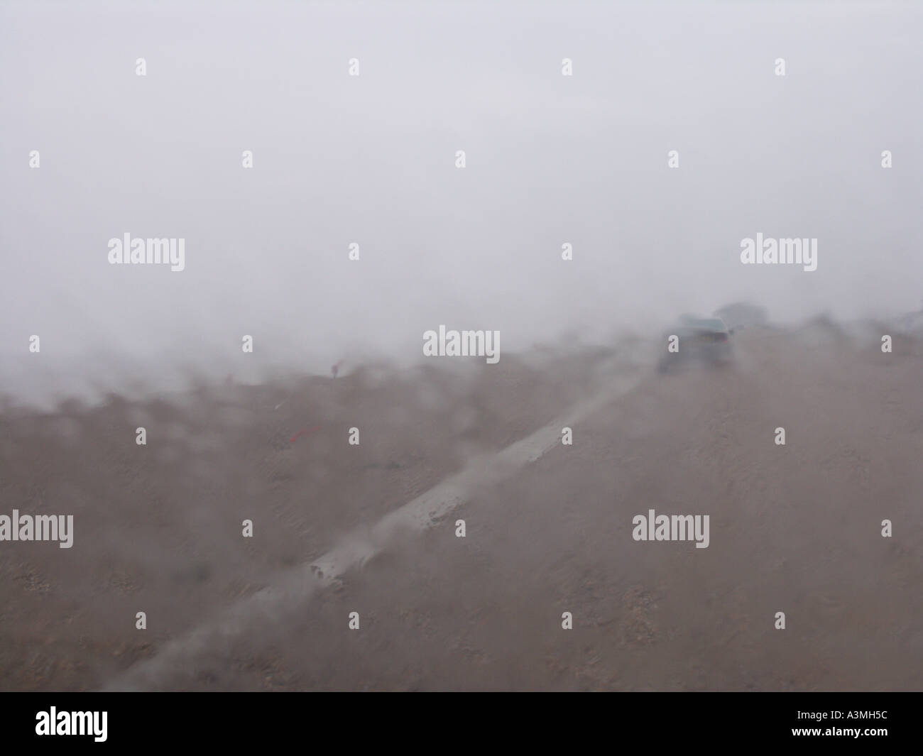 Heavy rain falling on car windscreen Stock Photo
