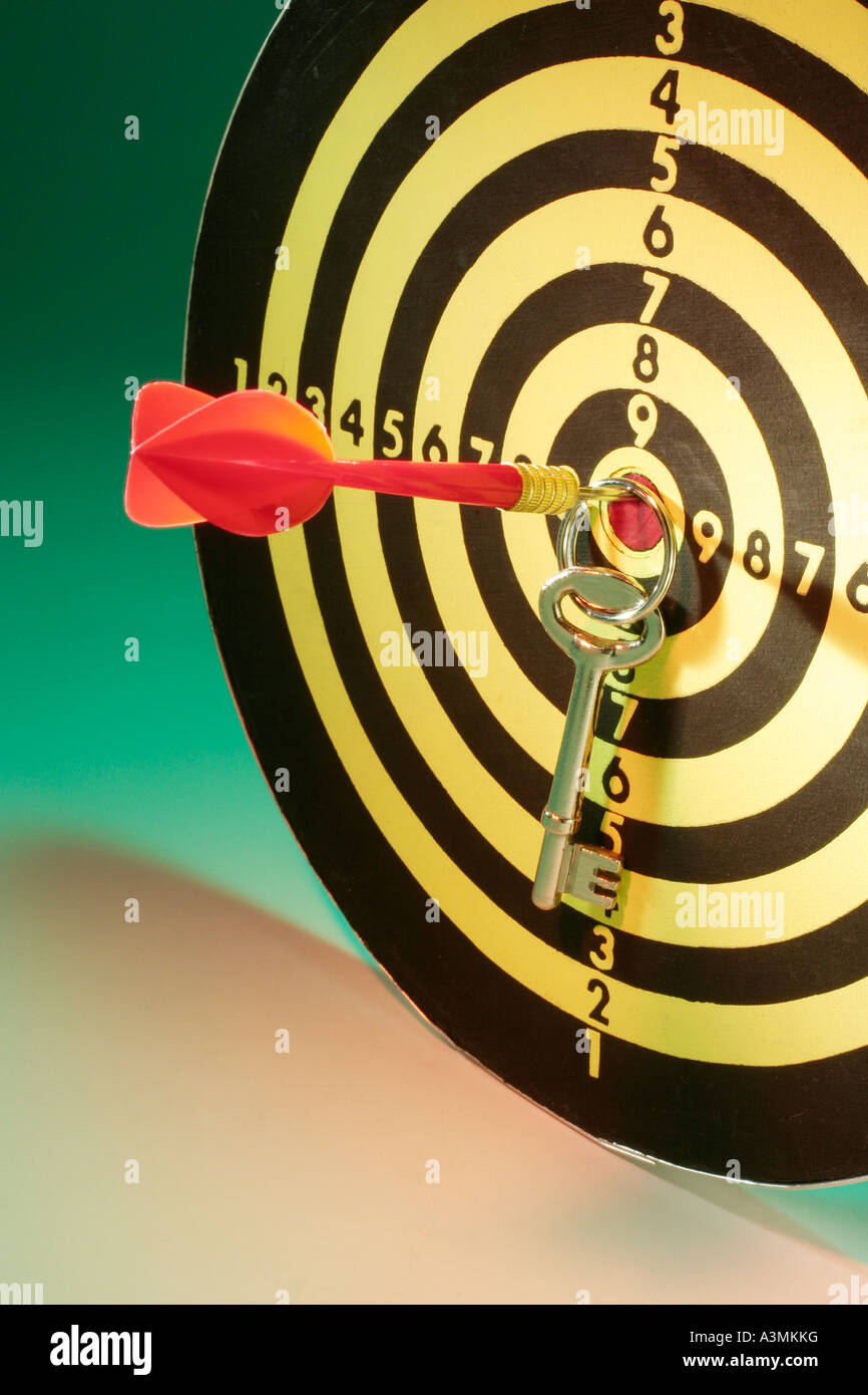 Key and Dart on Dartboard Stock Photo Alamy