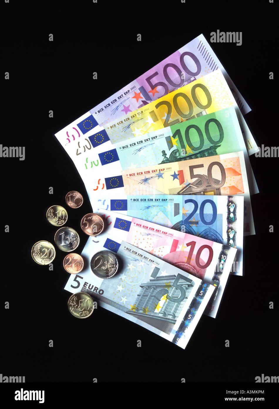 THE 7 DIFFERENT EURO BANKNOTES WITH EURO AND CENT COINS Stock Photo