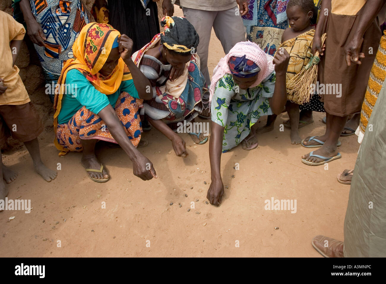 Three village women playing a game of Dara with sunflower seeds