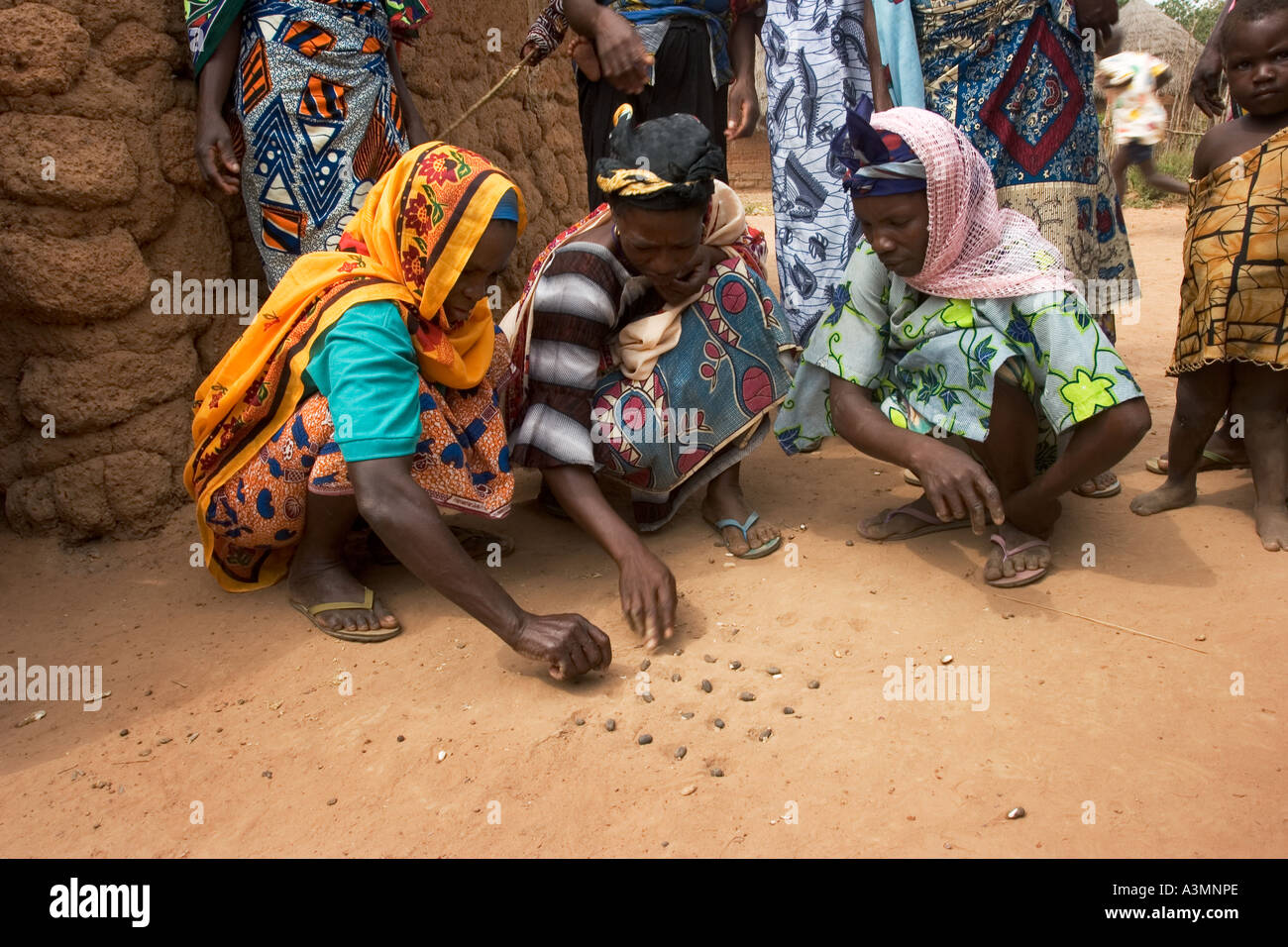 Three village women playing a game of Dara with sunflower seeds
