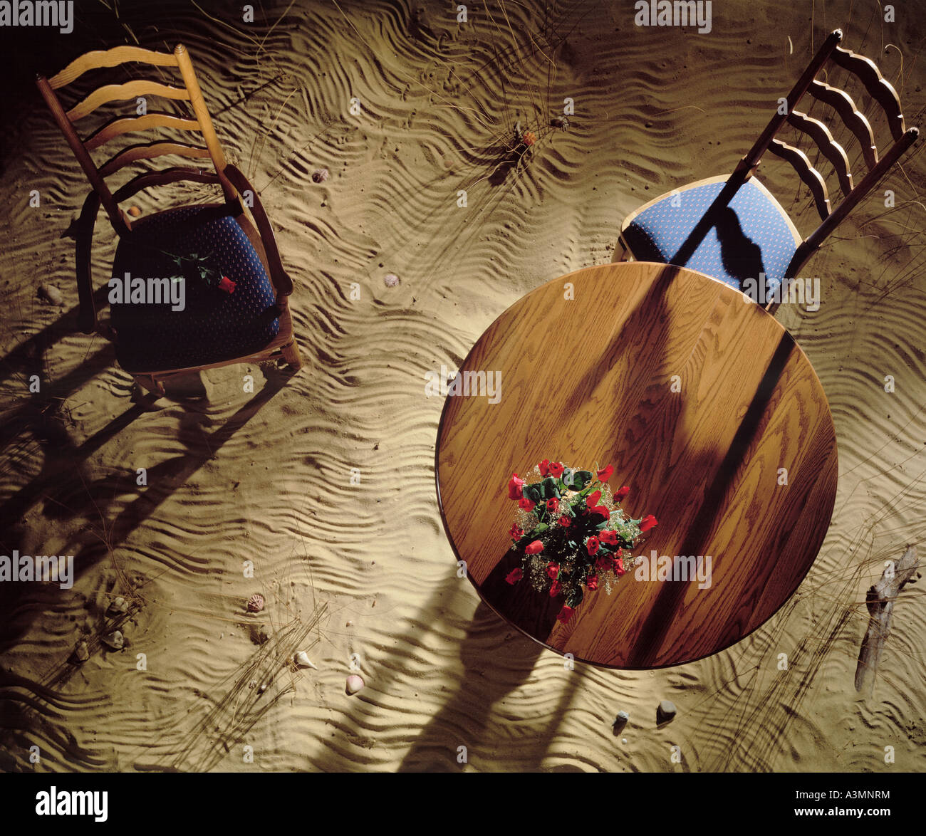 Overhead view round wood wooden table 2 two chairs on desert sand ...