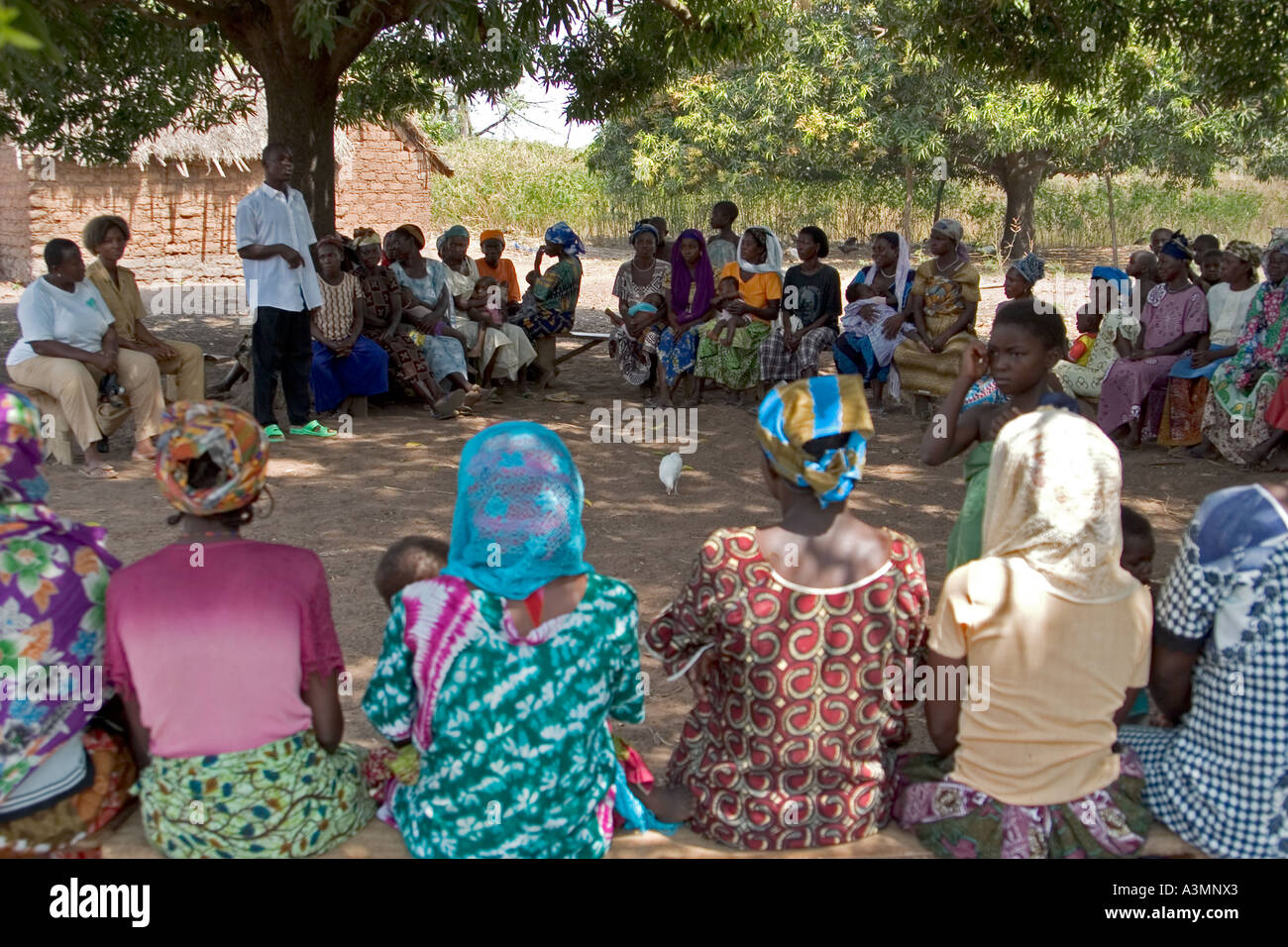 Local women in Northern Ghana listening to spokesman talking about alternative livelihood projects Stock Photo