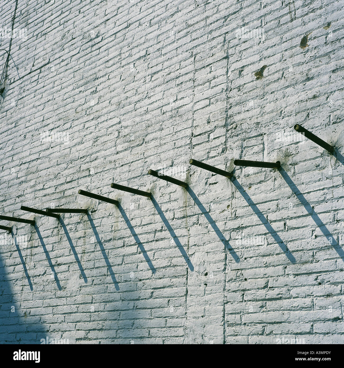 brick wall with a row of steel bars protruding Stock Photo Alamy