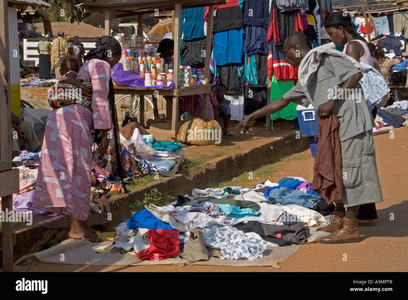 Local people buying and selling secondhand clothes in street market