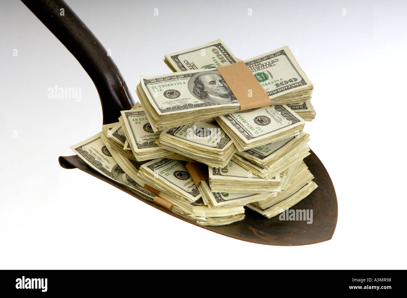 shovel full of US 100 dollar bills Stock Photo Alamy
