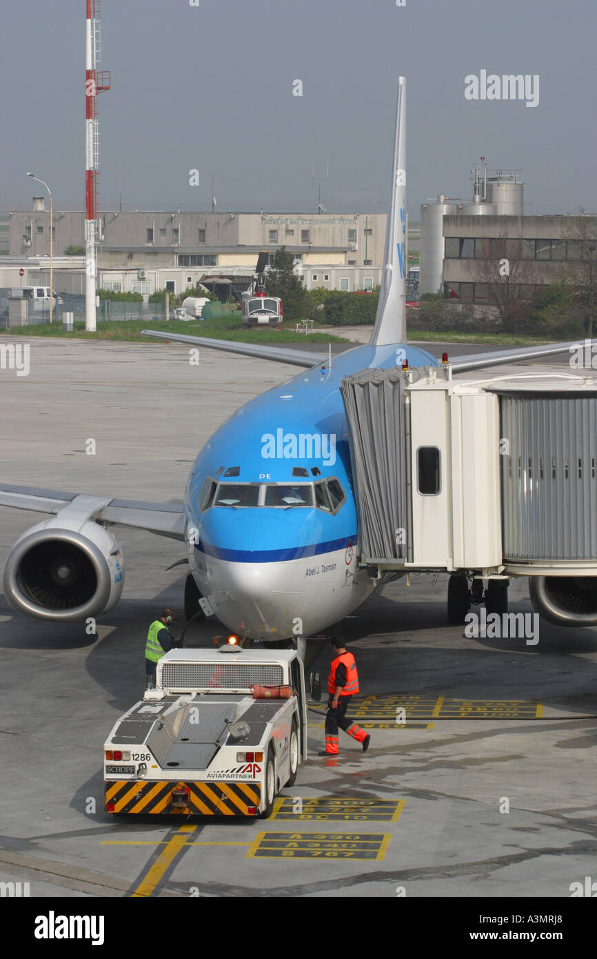 KLM Boeing 737 at airport apron ramp turnaround scene with tug and groundcrew Stock Photo