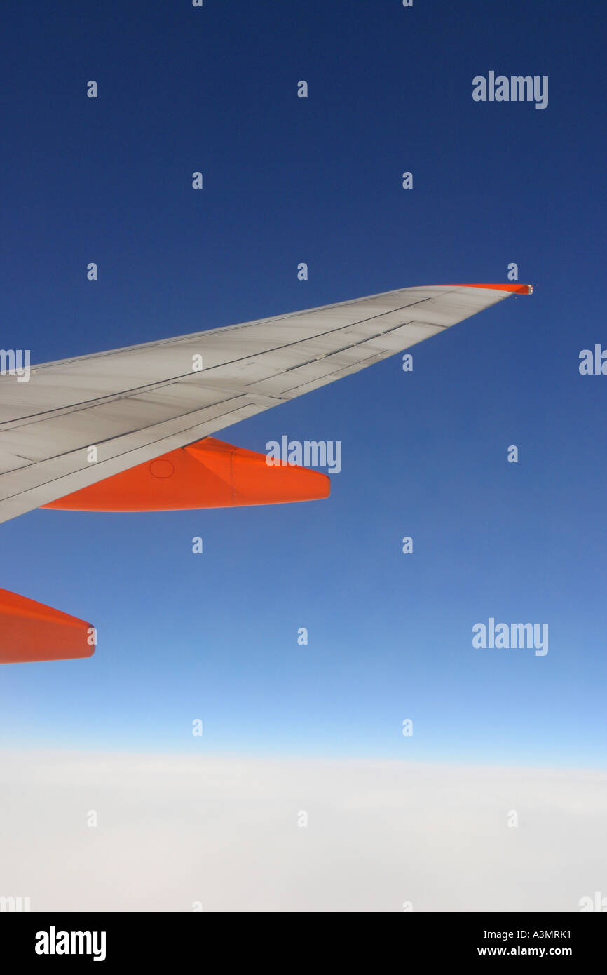View from passenger cabin of airliner wing in flight Easyjet Stock Photo