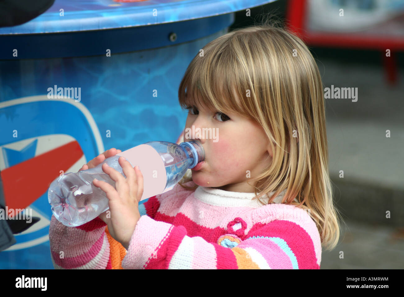 young child drinking water from a plastic bottle Stock Photo Alamy