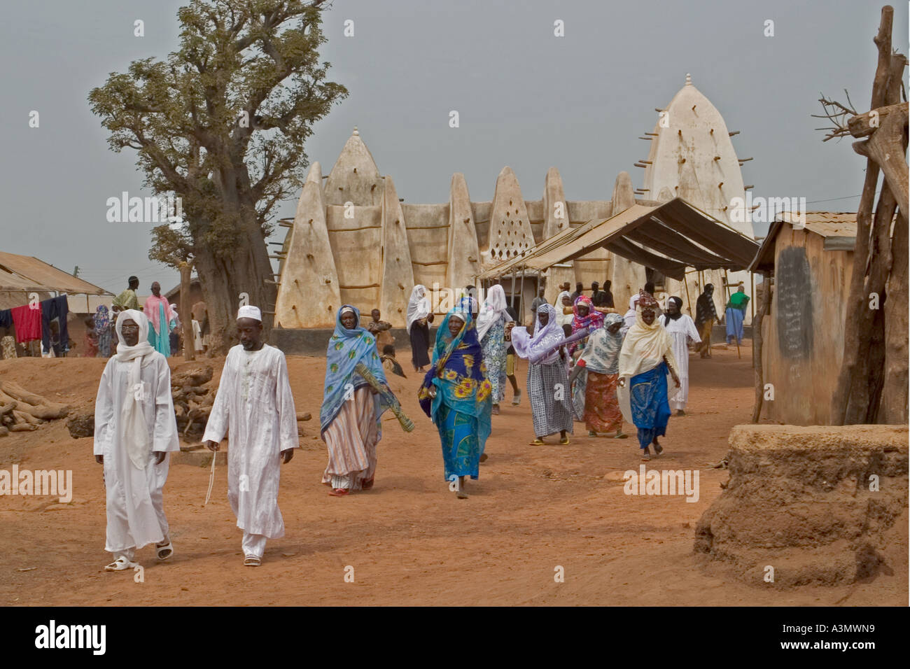 Village worshippers leaving Larabanga Mosque after Friday Prayers, Larabanga, Northern Ghana, Stock Photo