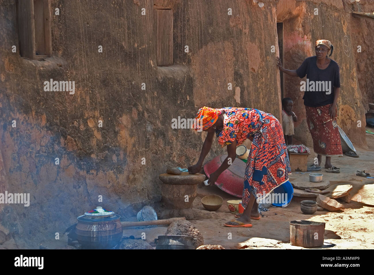 Village woman, Larabanga, Ghana, preparing food for cooking on open firehouse. Stock Photo