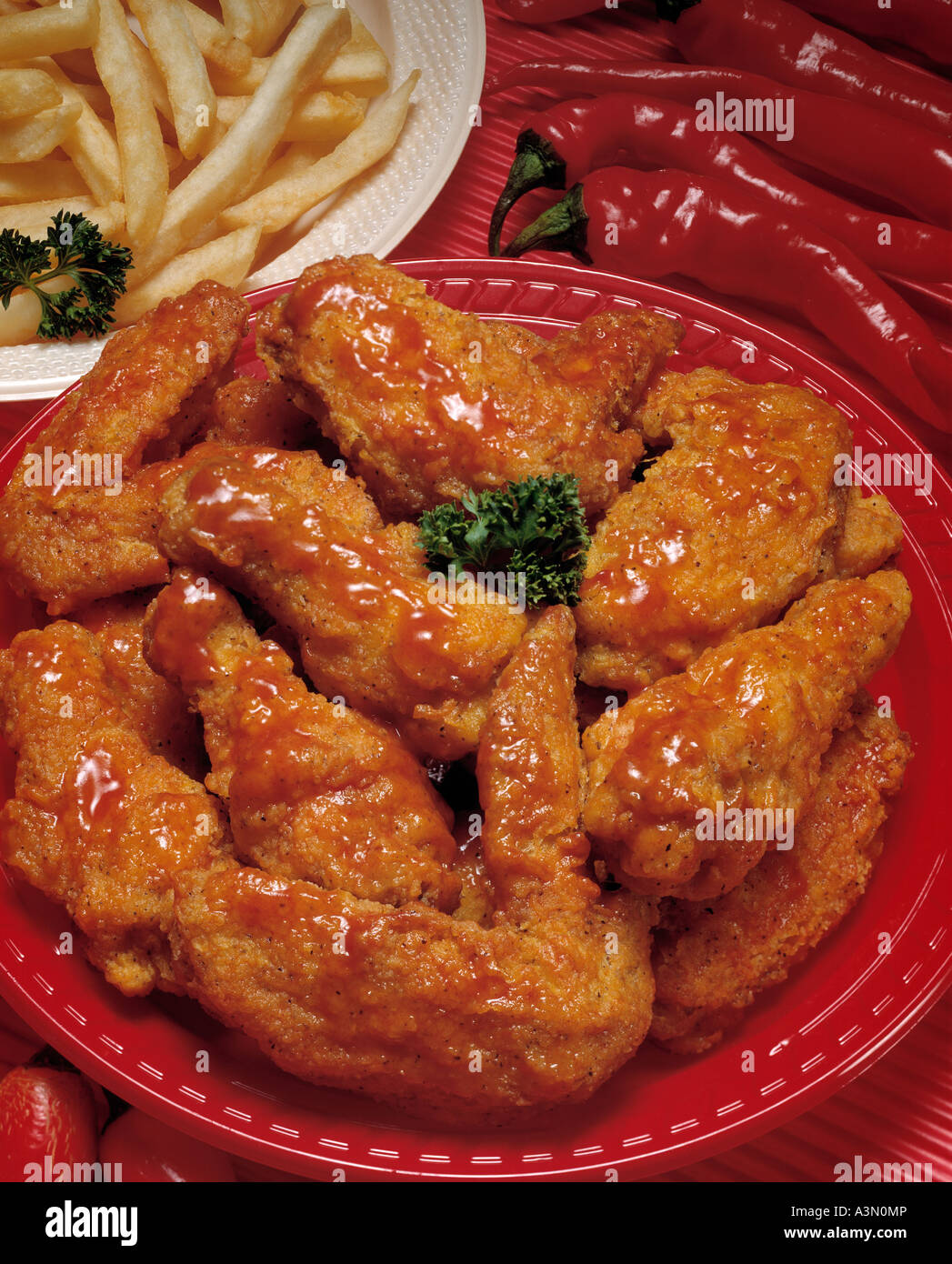 platter red hot chicken wings french fry fries peppers Stock Photo - Alamy