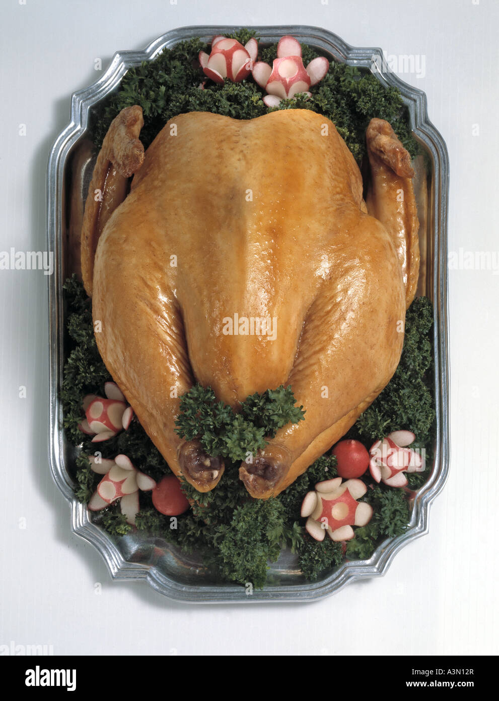 over head view chicken  pewter  platter garnished radish Holiday Thanksgiving Christmas Stock Photo