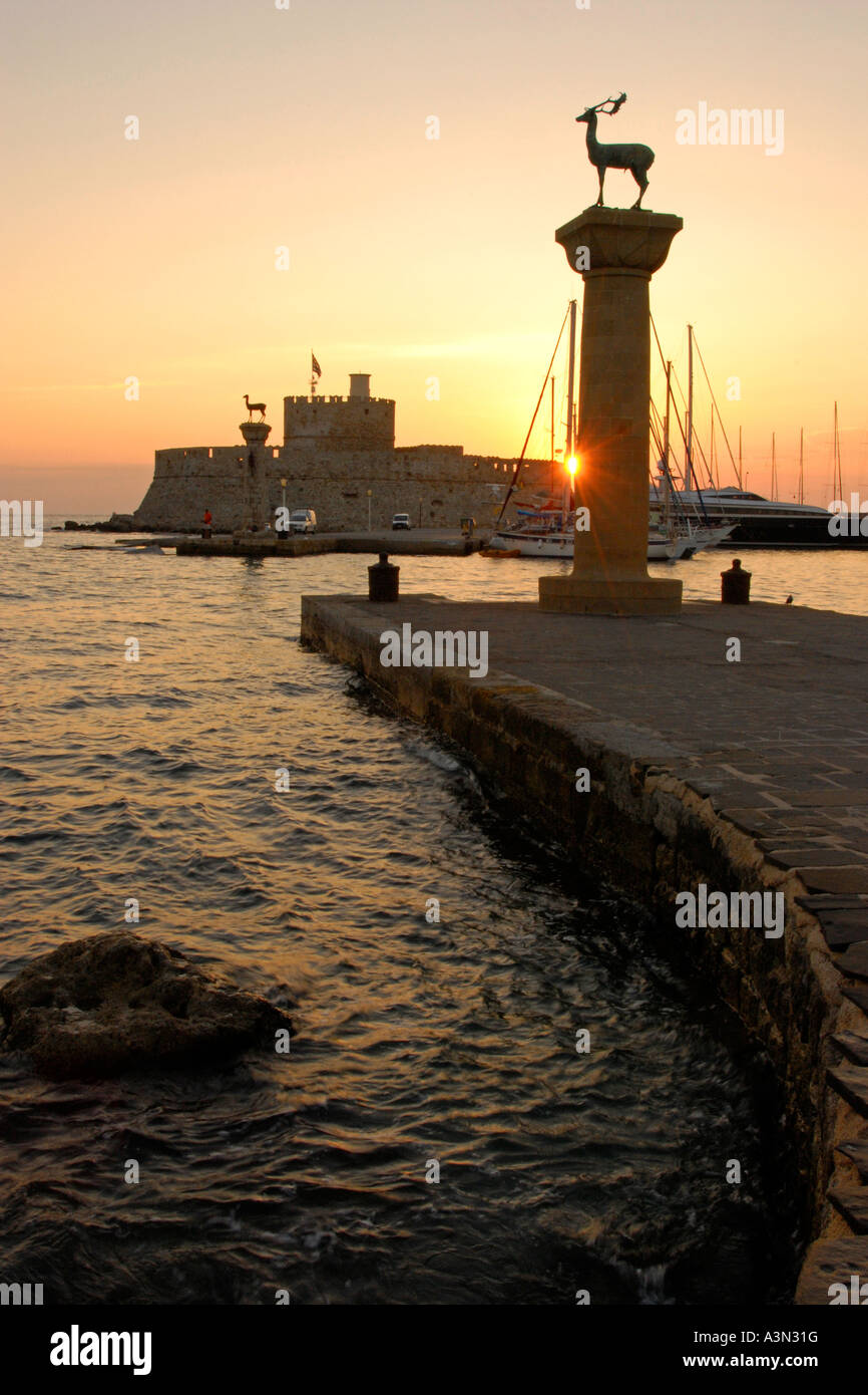 Mandraki Harbor entrance at sunrise, Rhodes, Greece Stock Photo - Alamy
