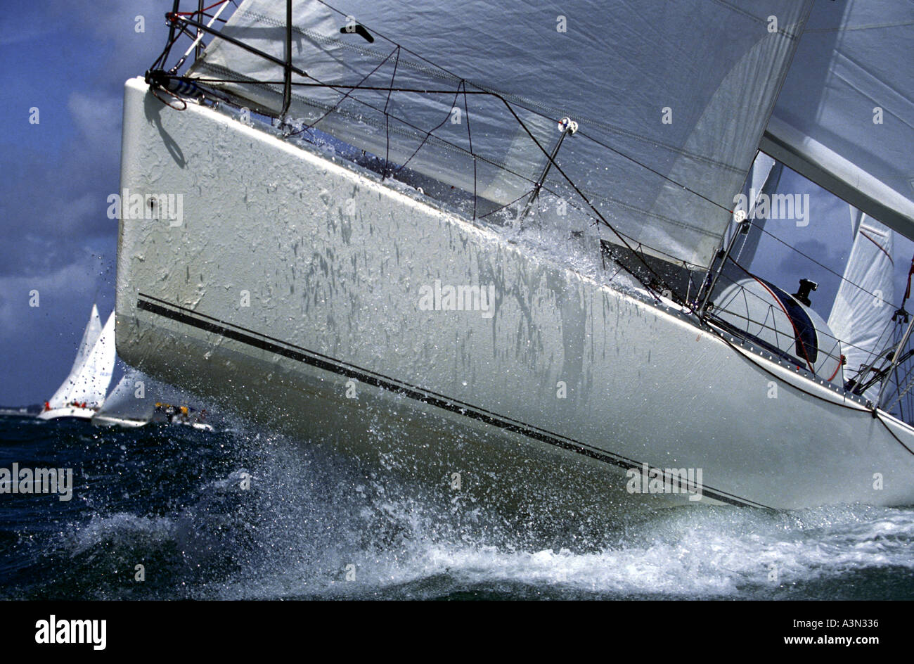 The bow of a Beneteau racing yacht rising out of the water Spi Ouest Race Week France Stock Photo