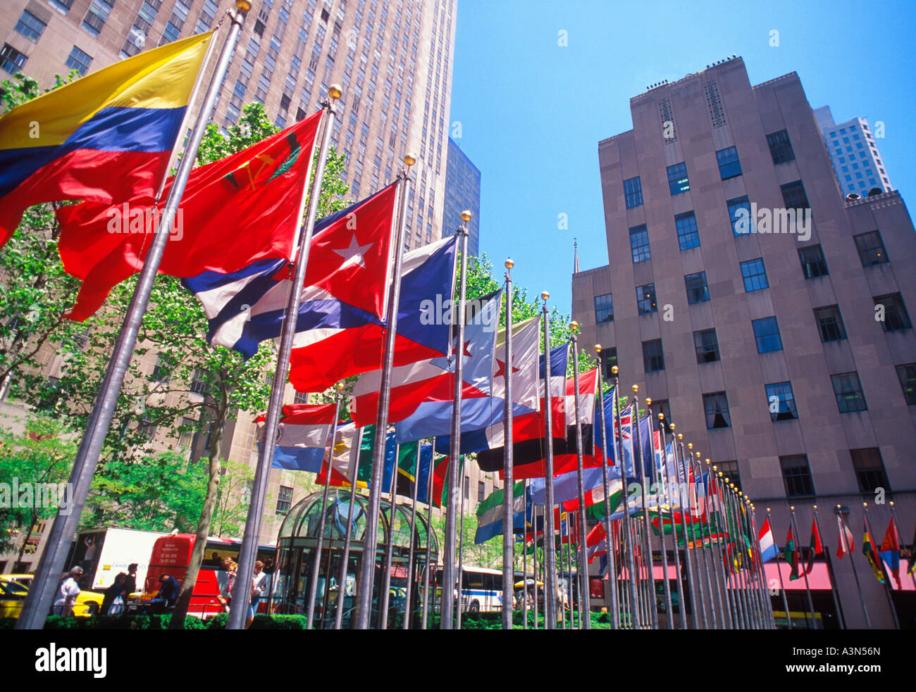 New York City Rockefeller Center Plaza and the Rockefeller Center complex of buildings. International flags circle the skating rink. Stock Photo