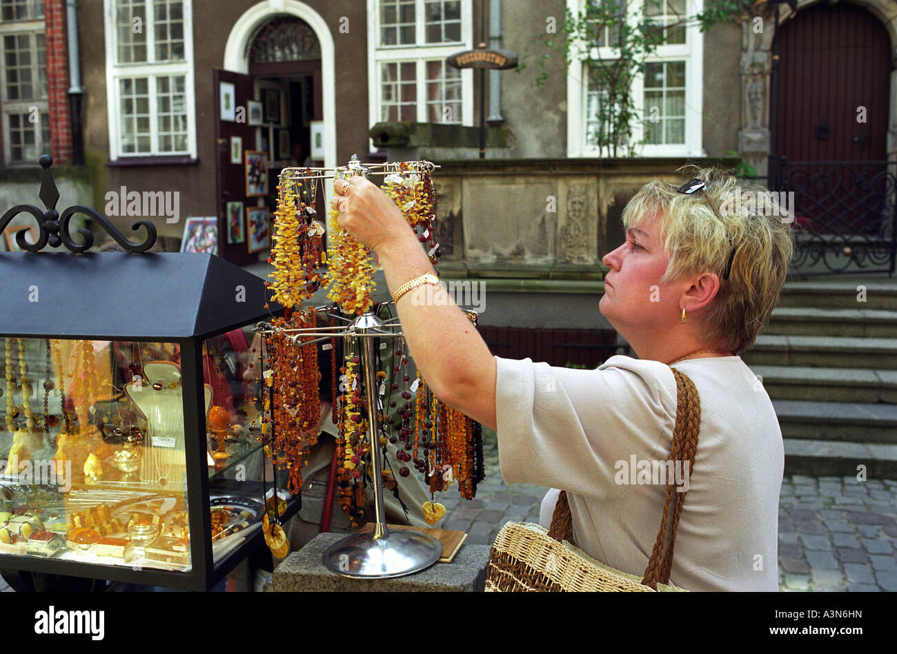 Woman looking at amber jewellery, Poland Stock Photo - Alamy