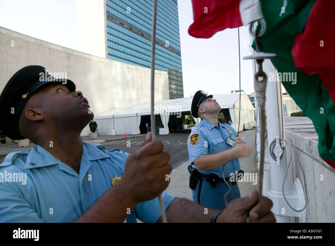 Security guards raise member states flags in front of the UN general secretariat building in New York USA USA September 2005 Stock Photo