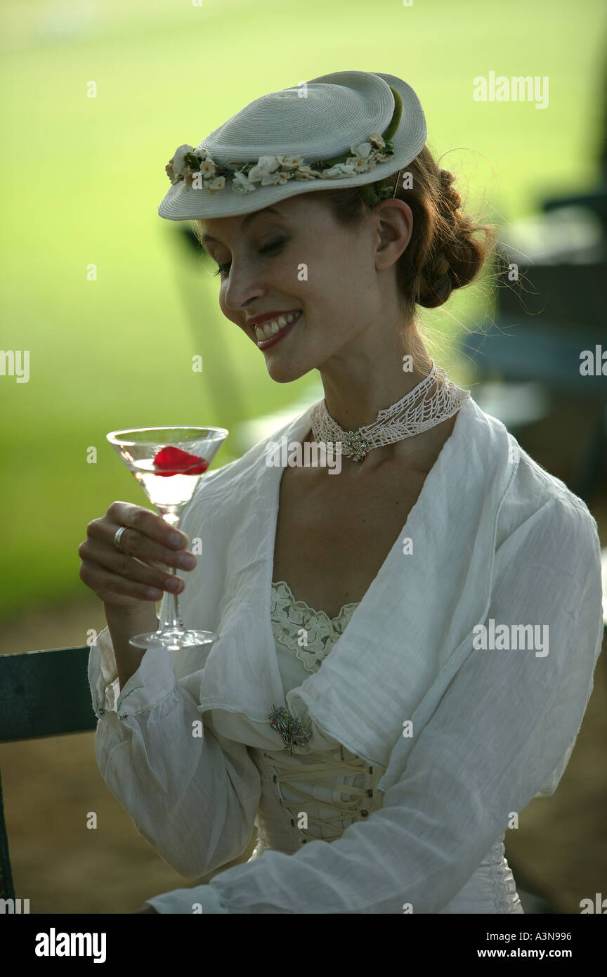 a traditional English girl drinking a martini cocktail Stock Photo - Alamy