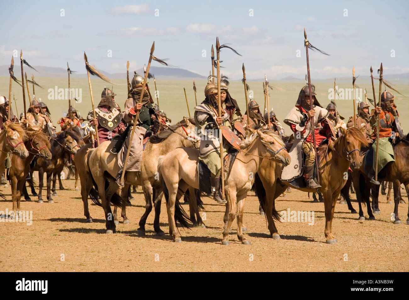 Mongolian warriors on horses armed with spears mustering for battle Stock Photo