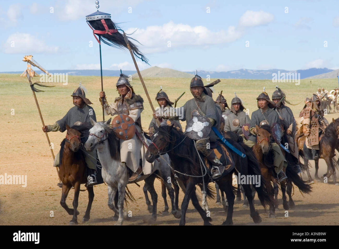 armed mongolian cavalry with black yak-tail war banners including a blue eyed horse Stock Photo