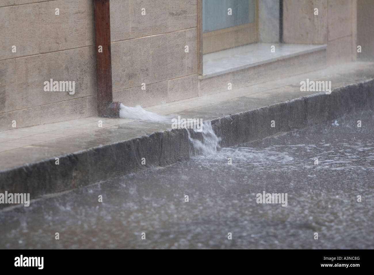 Heavy rain flooding out of drain pipe Stock Photo Alamy