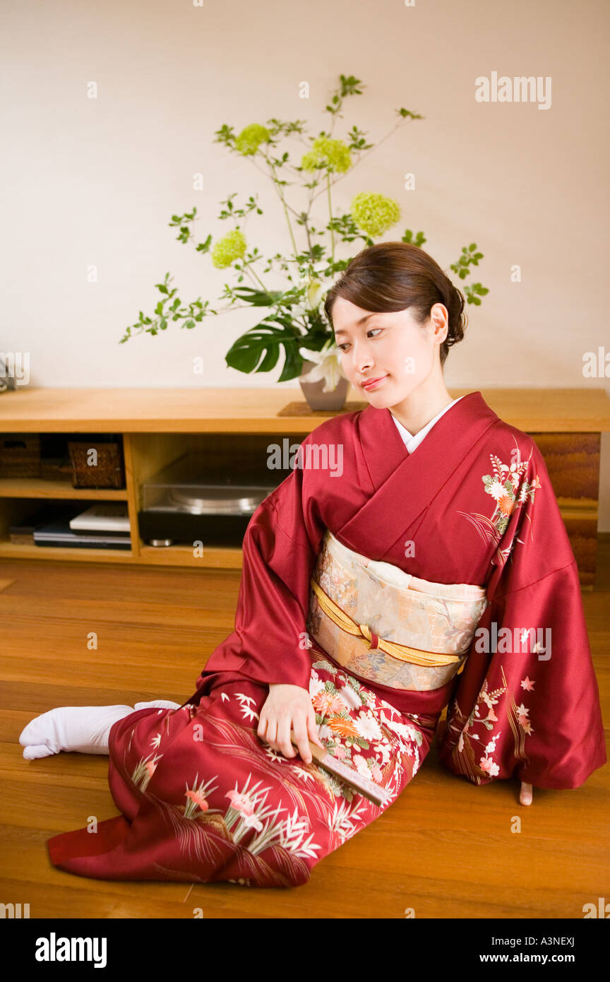 A young woman wearing kimono sitting on floor Stock Photo - Alamy