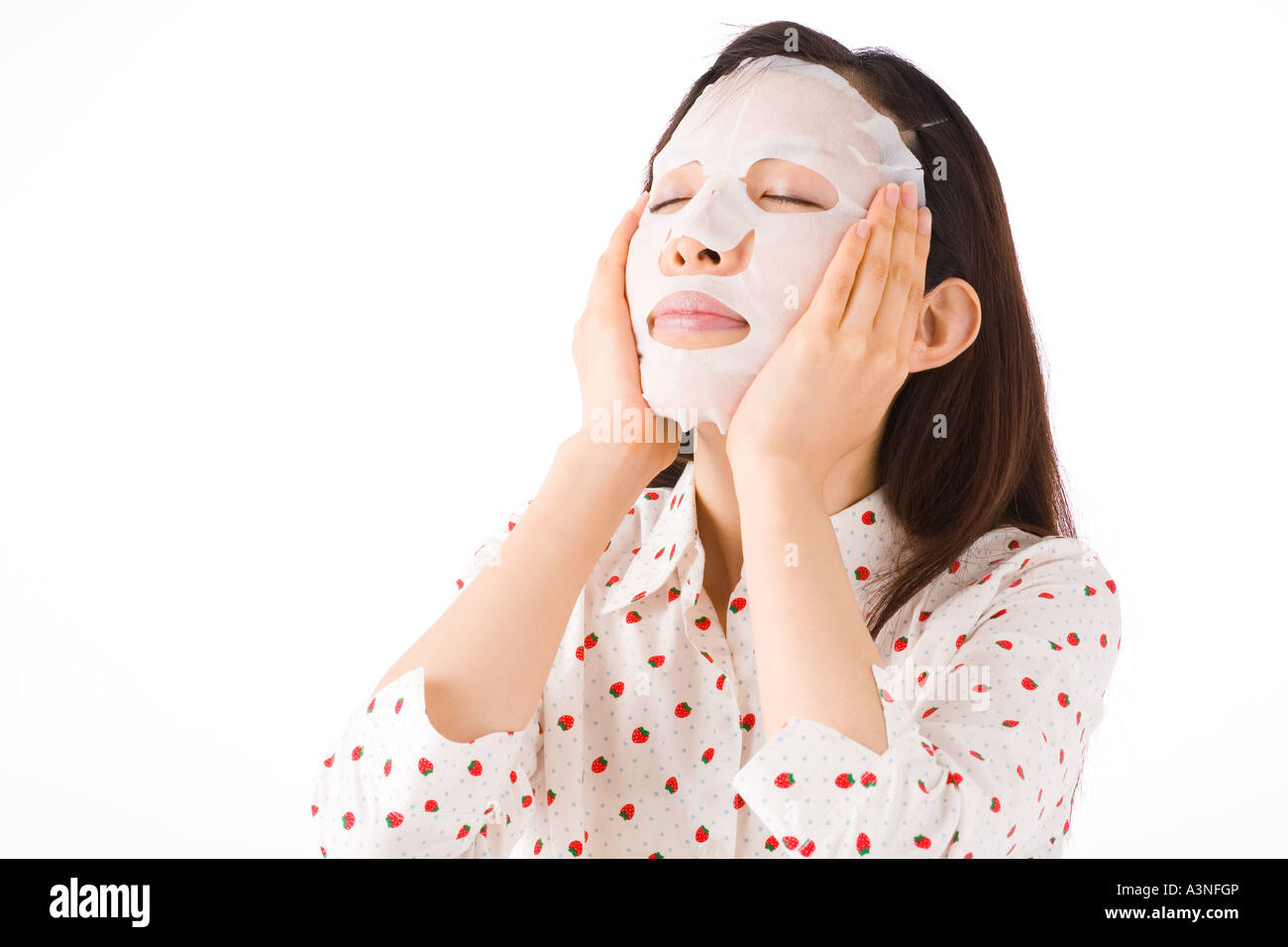 A woman applying facial mask Stock Photo