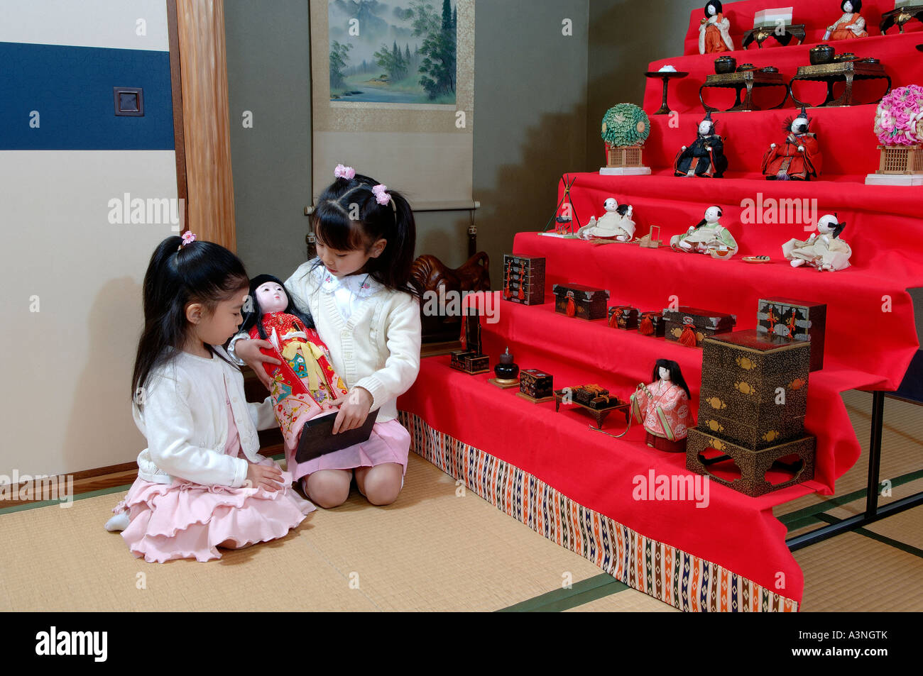 Girls playing with doll Stock Photo Alamy