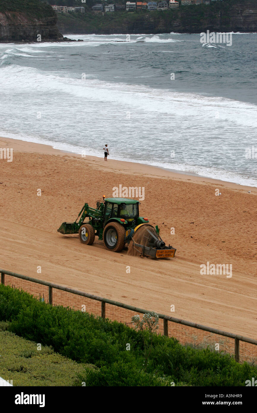 A tractor rakes and cleans the beach in Newport Australia Stock Photo ...