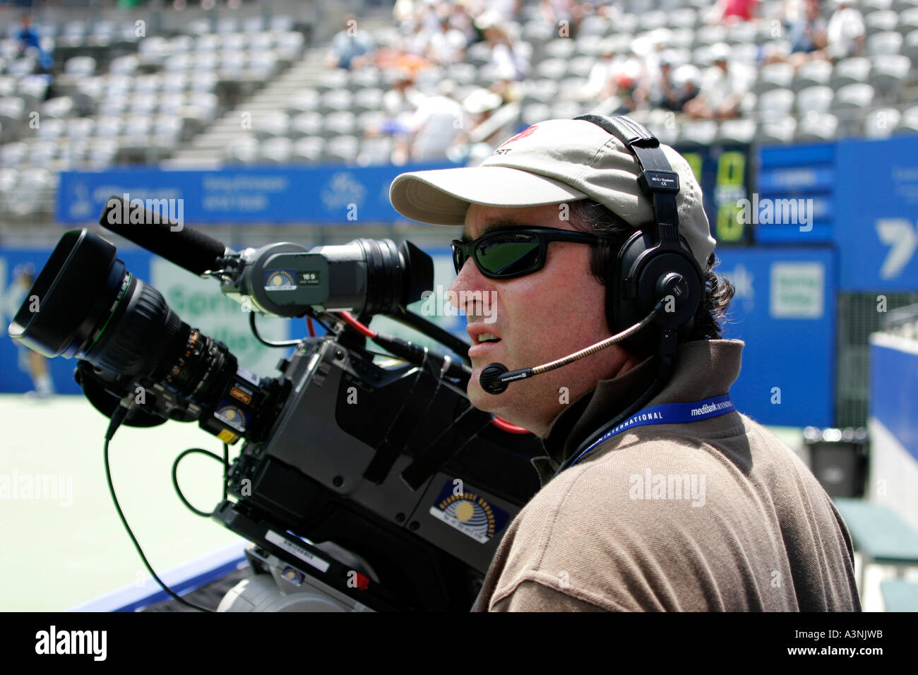 Television Cameraman at tennis match Stock Photo - Alamy
