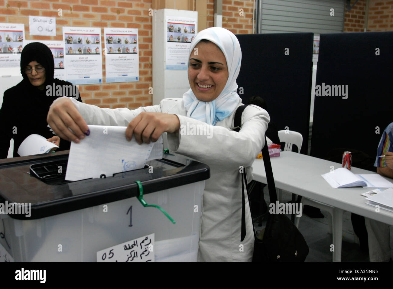 Smiling Muslim women wearing Hijaab vote in democratic elections for an Iraqi government Stock Photo