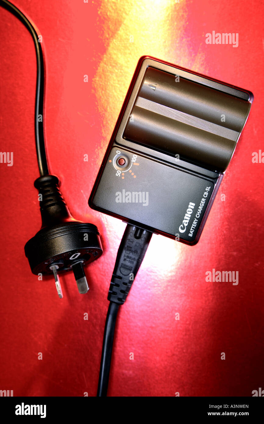 Camera battery in charger Stock Photo Alamy