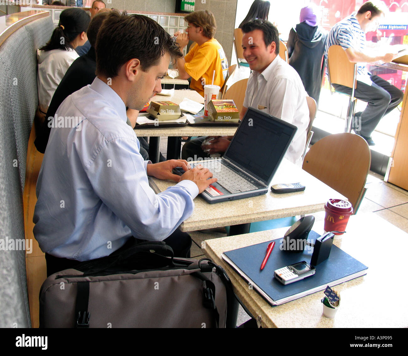 Man with laptop computer in a London cafe Stock Photo