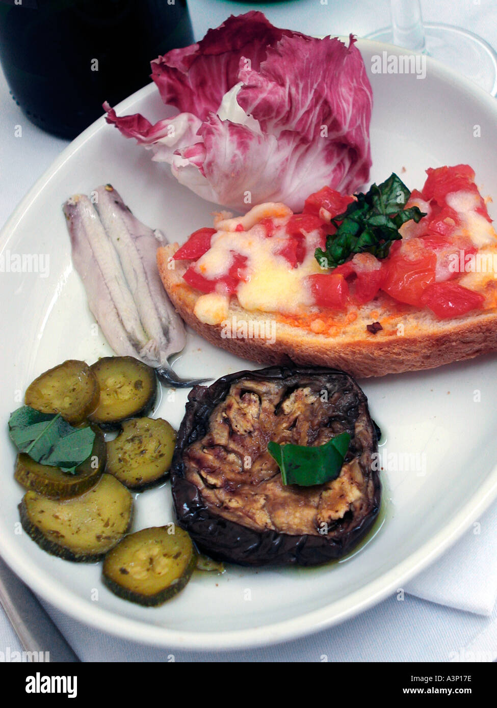 Antipasti plate of anchovy aubergine salad etc in restaurant in Italy