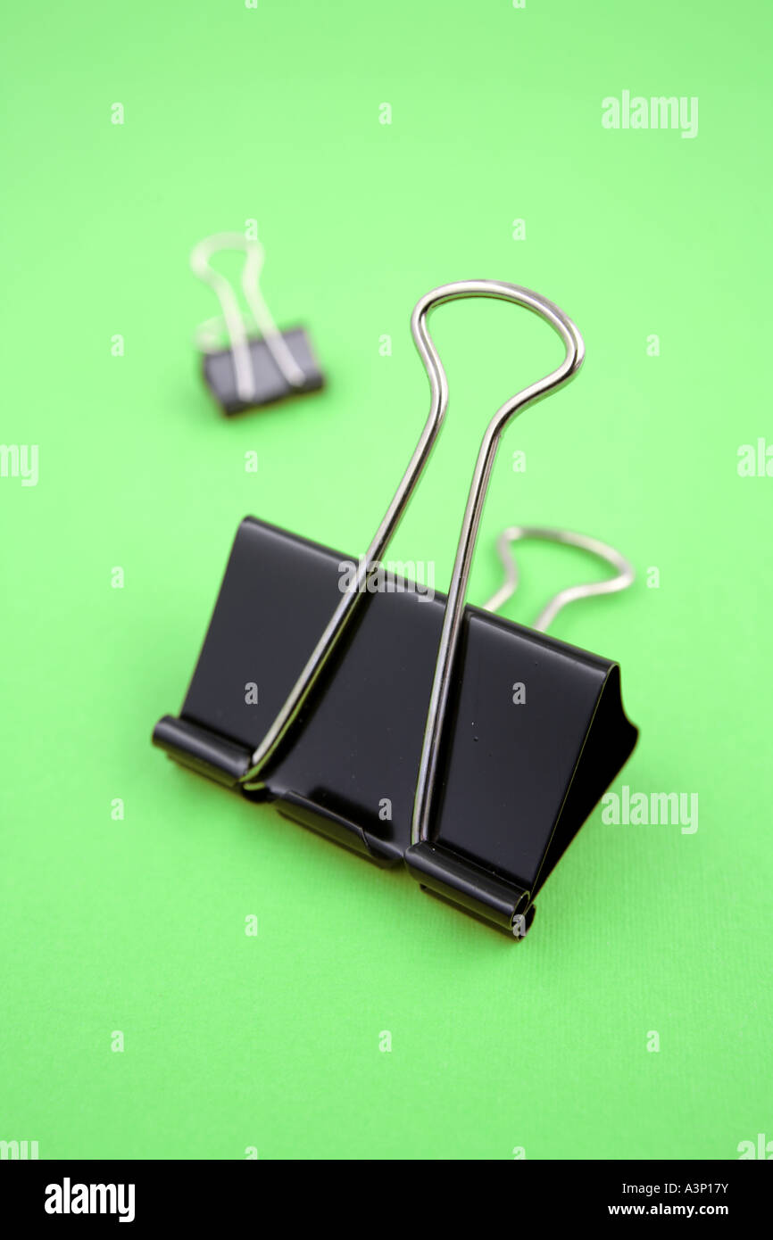 Binder clips on green background Stock Photo