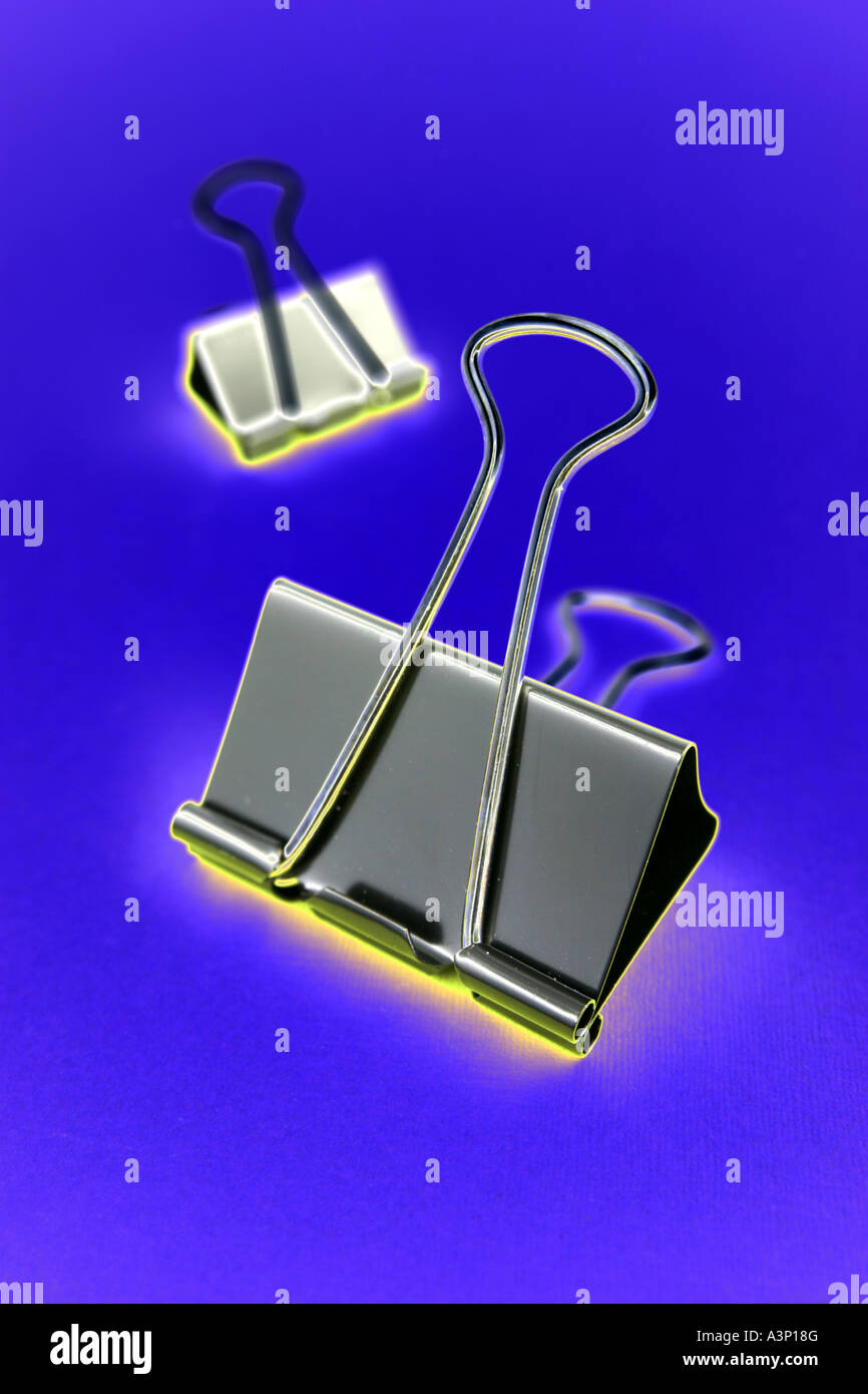 Binder clips on blue background Stock Photo