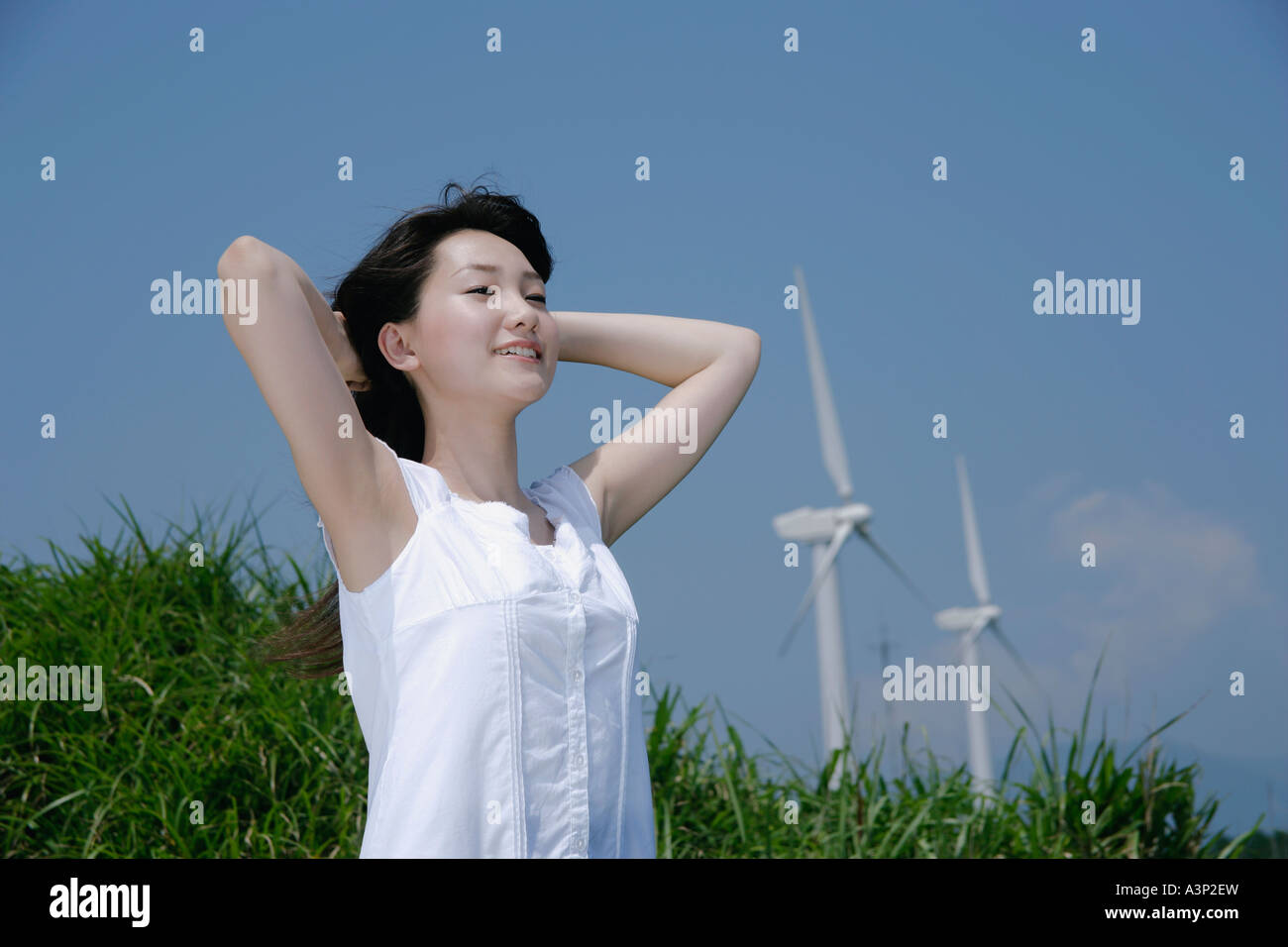A young woman standing in field Stock Photo - Alamy