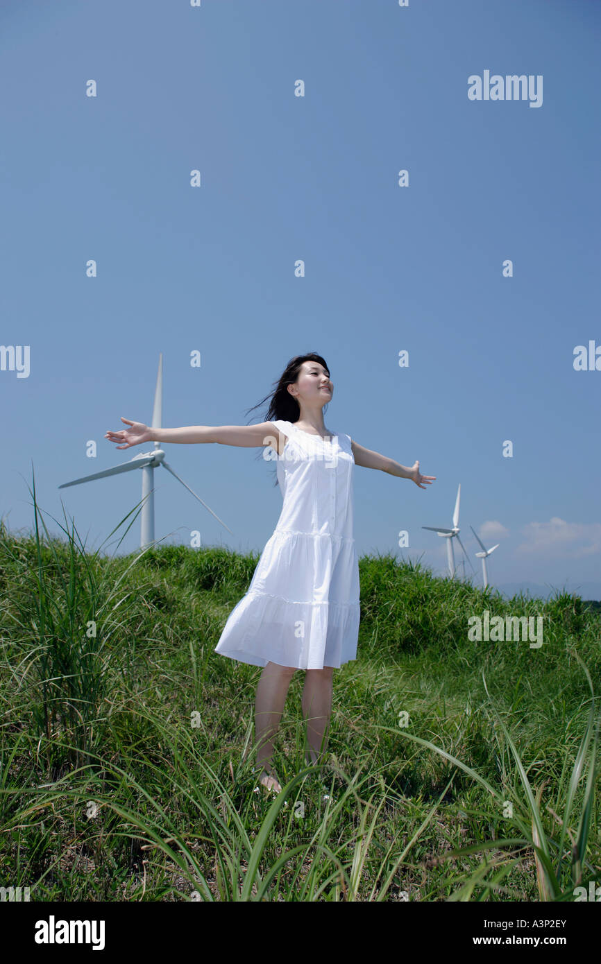 A young woman standing in field Stock Photo - Alamy