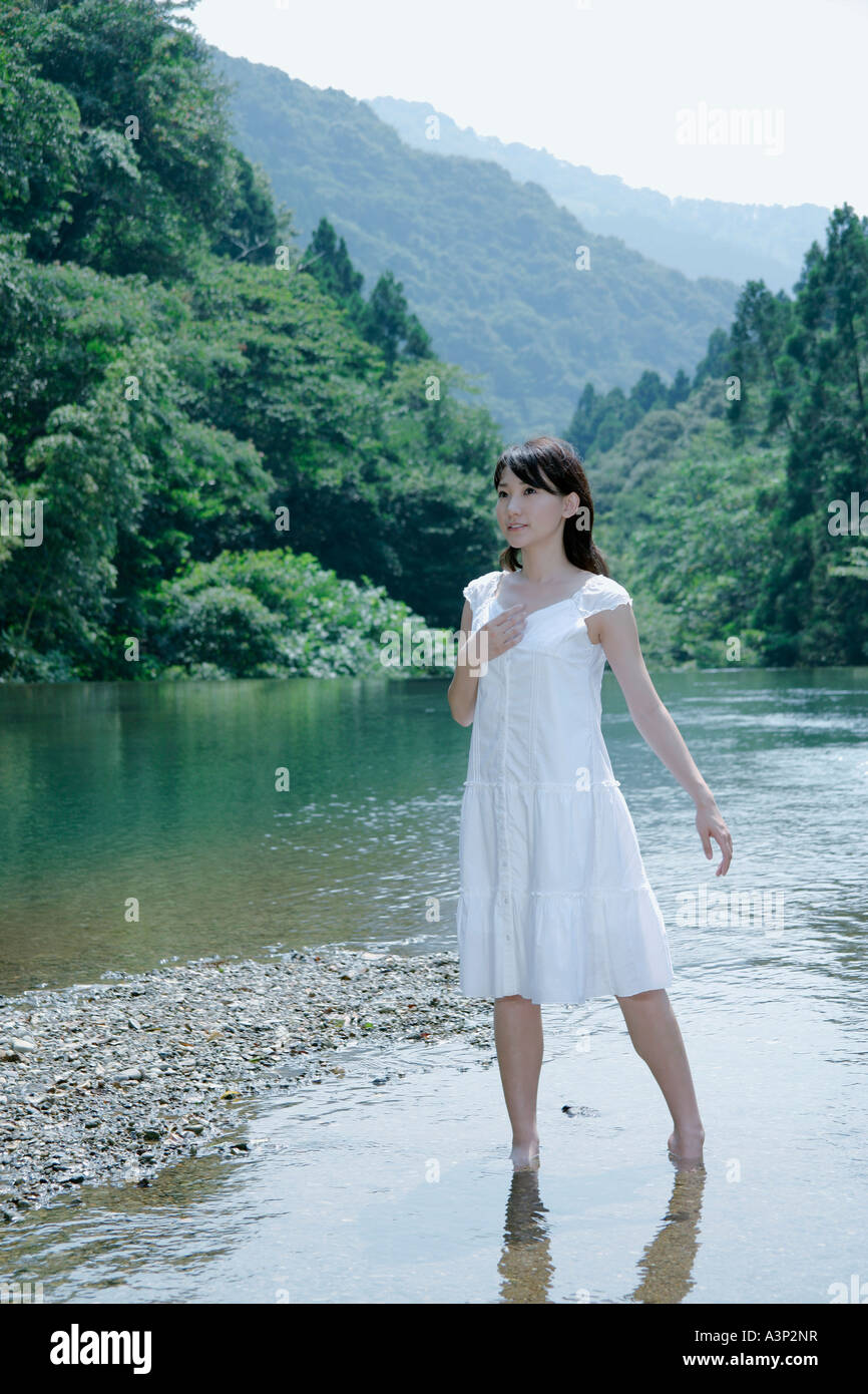 A young woman standing in river Stock Photo - Alamy