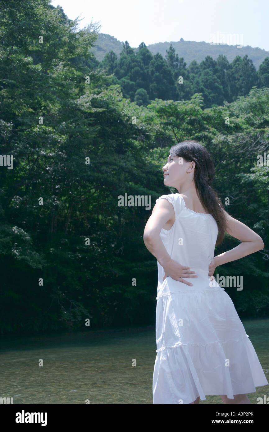 A young woman standing in river Stock Photo - Alamy