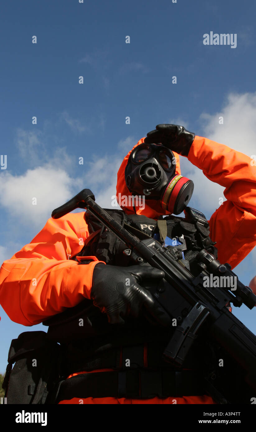 A British armed police officer dressed in an anti nuclear chemical warfare suit Stock Photo