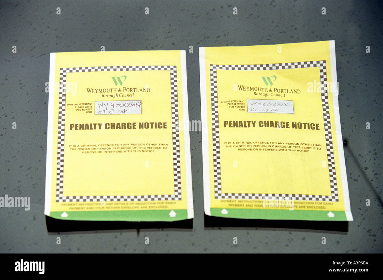 Two parking tickets on a car windscreen in Britain UK Stock Photo