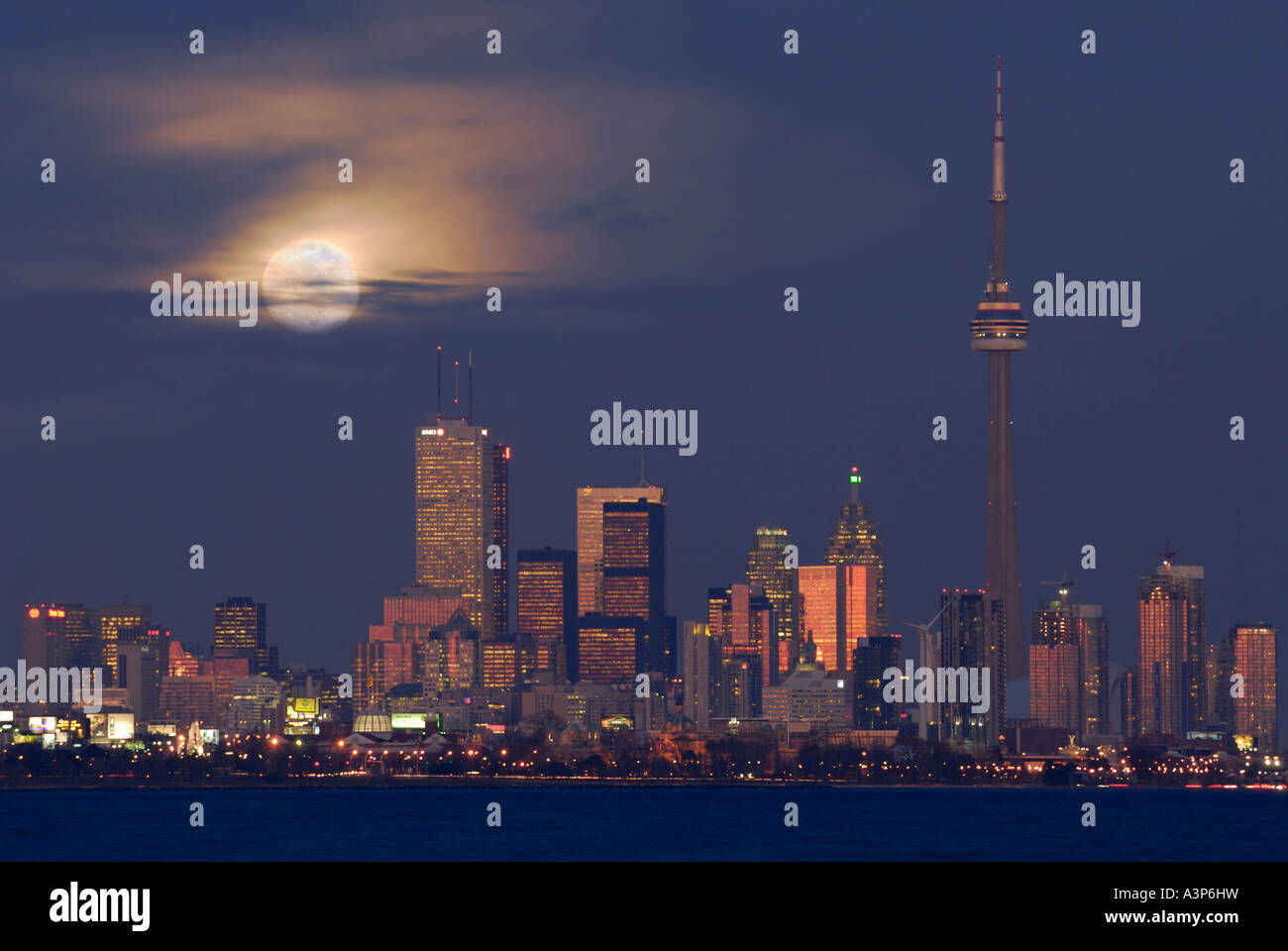 Toronto city skyline at dusk with rising moon in winter Stock Photo